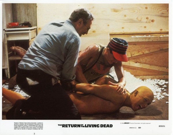 holding down the reanimated corpse in The Return of the Living Dead (1985)