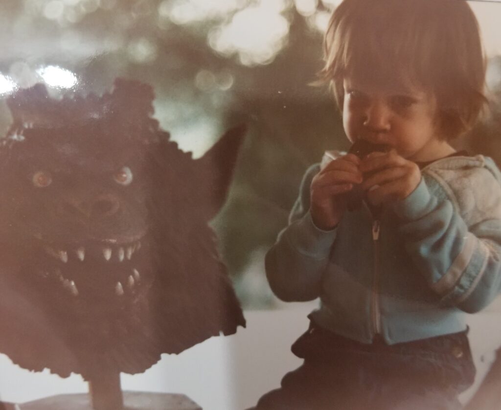 Lauren Tharp eating next to a Curse of the Demon mask