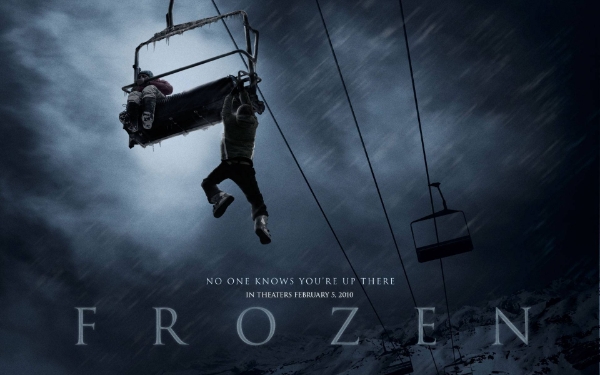 man dangling from a sky lift high in the air in Frozen