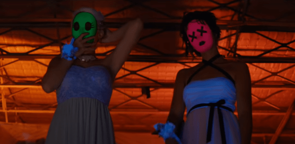 Teen girls in pretty dresses and weird masks in Tragedy Girls