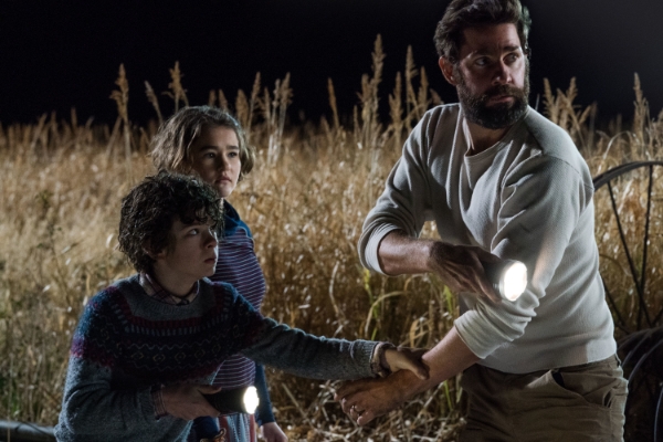 dad and his two kids in a field in A Quiet Place