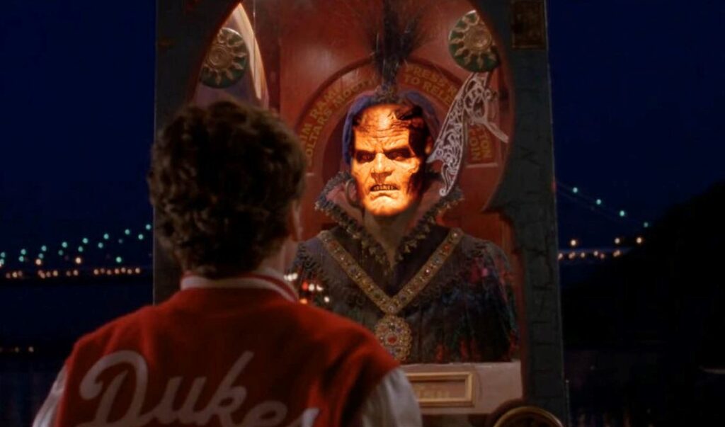 Screenshot of the Zoltar machine from Big with the face of the Djinn from Wishmaster 