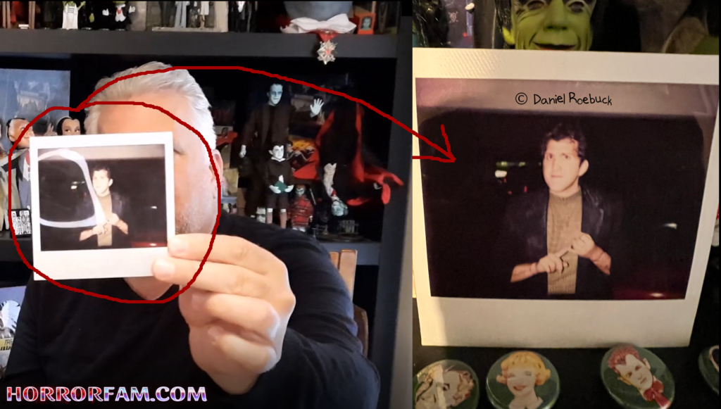 Actor Daniel Roebuck holding up a polaroid photo from when he auditioned to be Herman Munster in The Munsters Scary Little Christmas