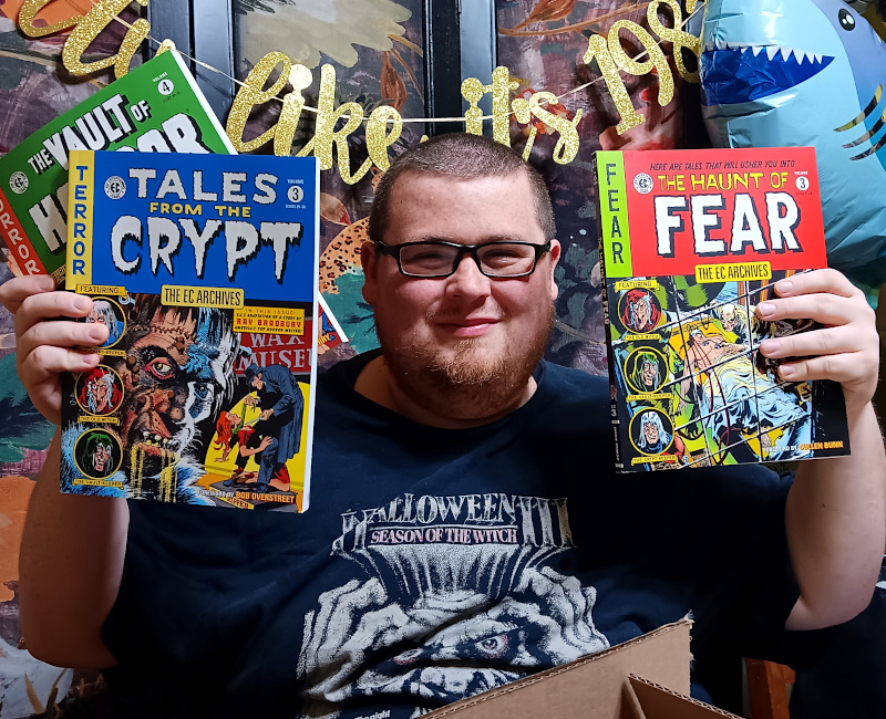 Frank Spear showing off the EC Comics he got for a gift from his wife on his 35th birthday